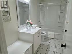 White vanity with a single basin, stainless steel faucet, and a framed mirror - 