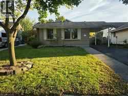 Brick-front exterior with white window shutters - 