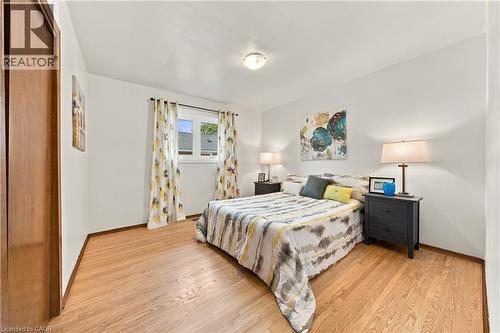Hardwood flooring, white walls, and a window with a white frame - 662 Dynes Road, Burlington, ON 