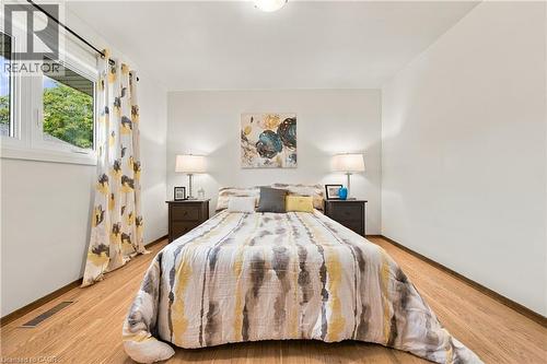 Recessed lighting, wood-finish flooring, white walls, and a large window - 662 Dynes Road, Burlington, ON 
