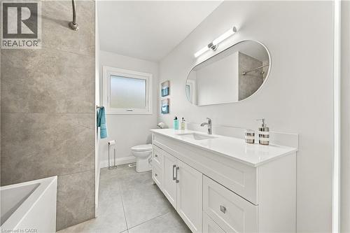 White vanity with a quartz countertop, rectangular undermount sink, and chrome faucet - 662 Dynes Road, Burlington, ON 