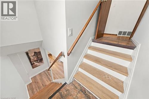 Staircase with wood-finish treads and risers, complemented by wood-finish handrails - 662 Dynes Road, Burlington, ON 