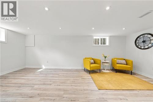 Recessed ceiling lighting, wood-finish flooring, white painted walls, and two visible windows - 662 Dynes Road, Burlington, ON 