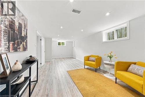 Recessed lighting, wood-finish flooring, white walls, and a window with white trim - 662 Dynes Road, Burlington, ON 