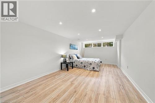 Wood-finish flooring, recessed lighting, and multiple windows - 662 Dynes Road, Burlington, ON 