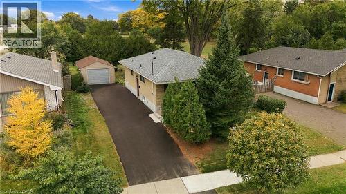 Single-story residence featuring a gray shingle roof, light-colored brick exterior, and an attached front entry - 662 Dynes Road, Burlington, ON 