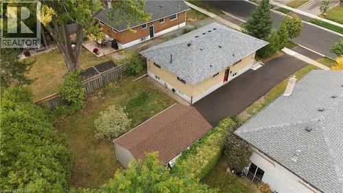 Expansive lot featuring a detached storage shed, mature trees, and an asphalt driveway - 662 Dynes Road, Burlington, ON 
