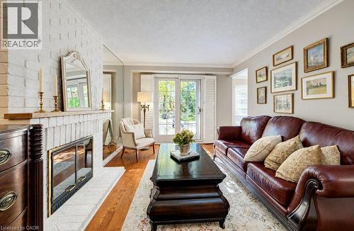 Main floor family room with fireplace and sliders to deck - 469 Westvale Drive, Waterloo, ON 