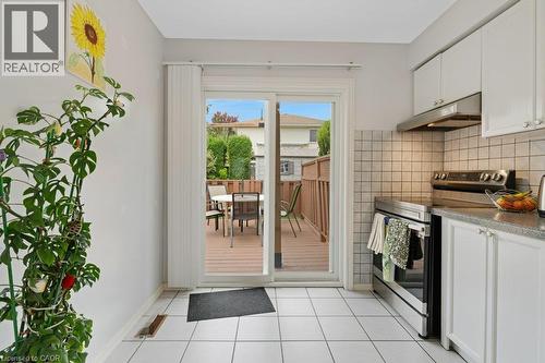 Kitchen with sliding door to deck and backyard - 94 Dawn Crescent, Cambridge, ON 