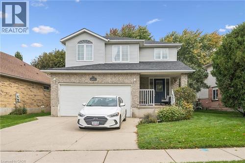 Two-story residence featuring brick and siding facade, an attached two-car garage, and a covered front entry - 233 Dearborn Boulevard, Waterloo, ON 