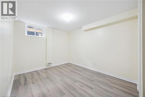 Recessed window, wood-finish flooring, white walls, overhead lighting, and trim details - 233 Dearborn Boulevard, Waterloo, ON 