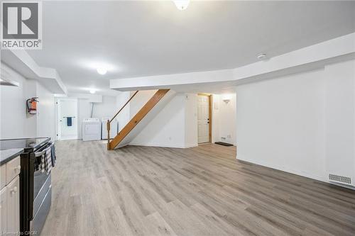 Open-concept space with wood-finish flooring, white walls, and recessed lighting - 233 Dearborn Boulevard, Waterloo, ON 