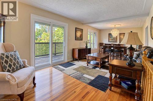 Hardwood flooring, sliding glass door, recessed ceiling detail, and a built-in balcony - 1370 Thorman Place, Cambridge, ON 