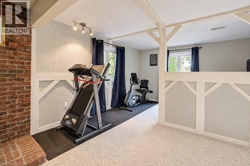 Textured walls with exposed ceiling beams and a track lighting fixture - 1370 Thorman Place, Cambridge, ON 