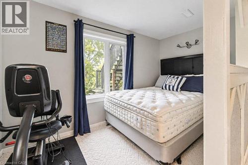 Wall-to-wall carpeting with a geometric pattern, neutral wall paint, and a window with a dark curtain rod - 1370 Thorman Place, Cambridge, ON 