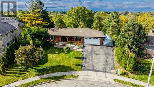 Brick exterior with an attached garage, paved driveway, and manicured front lawn - 1370 Thorman Place, Cambridge, ON 