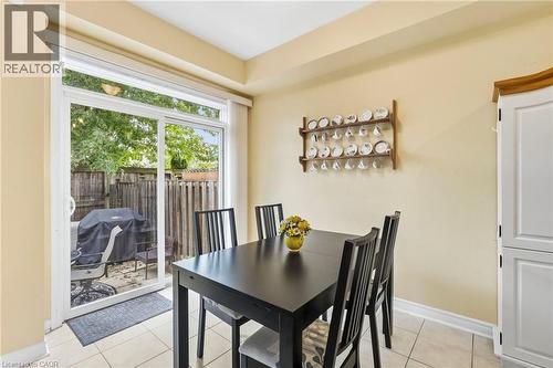 Sliding glass door, tiled flooring, light-colored walls and white cabinetry - 1076 Ryckman Common, Burlington, ON 