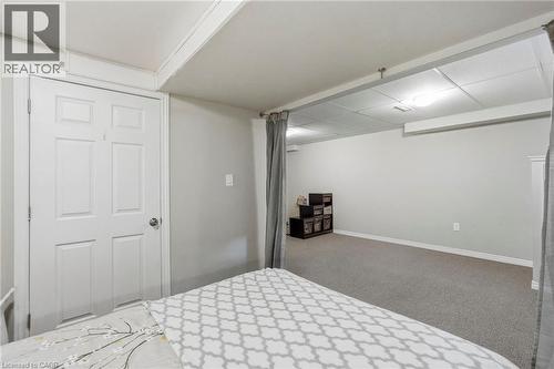 Recessed lighting illuminates the space, featuring light gray wall paint and gray carpeting - 1076 Ryckman Common, Burlington, ON 