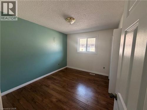 Wood-finish flooring with white trim - 37 Elora Drive, Hamilton, ON 