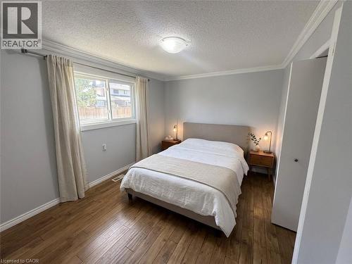 Wood-finish flooring, crown molding, and a double window - 37 Elora Drive, Hamilton, ON 