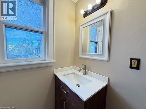 Modern vanity with an integrated sink, white countertop, and brushed nickel faucet - 507 Aberdeen Avenue, Hamilton, ON 