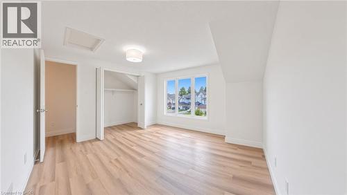 Bright room featuring wood-finish flooring, white walls, and a multi-pane window - 250 Parkvale Drive, Kitchener, ON 