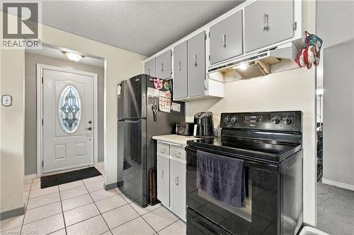 White paneled entry door with decorative glass insert - 135 Cedarhill Crescent, Kitchener, ON 
