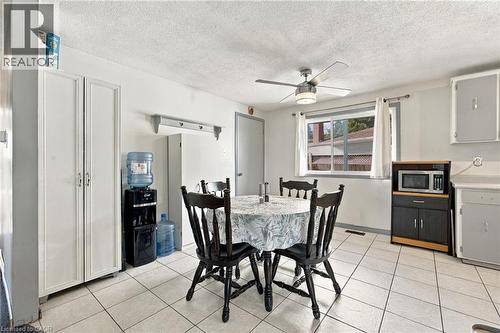 Recessed window, ceiling fan with integrated lighting, wall-mounted shelving, and white tile flooring - 135 Cedarhill Crescent, Kitchener, ON 