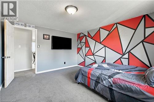 Wall-mounted television with visible electrical outlet - 135 Cedarhill Crescent, Kitchener, ON 