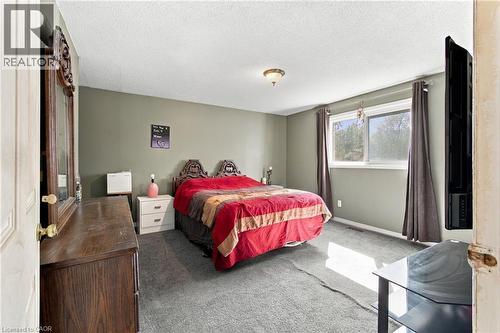 Wall-mounted light fixture, dual pane window, and wall-to-wall carpeting - 135 Cedarhill Crescent, Kitchener, ON 