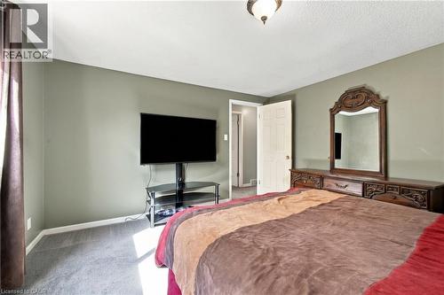 Carpeted flooring with an overhead ceiling light fixture - 135 Cedarhill Crescent, Kitchener, ON 