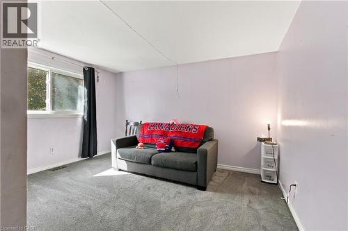 Carpeted flooring, light-toned walls, and a white framed window - 135 Cedarhill Crescent, Kitchener, ON 