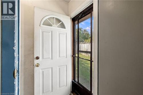White paneled door with an arched transom window and brass hardware - 135 Cedarhill Crescent, Kitchener, ON 