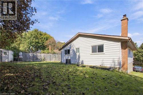 Wood-paneled fence enclosing a grassy yard - 135 Cedarhill Crescent, Kitchener, ON 