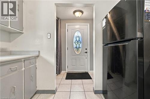 White panel door with an oval stained-glass insert and transom window - 135 Cedarhill Crescent, Kitchener, ON 