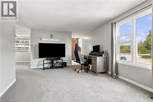 Expansive room with neutral gray walls and light gray carpeting - 135 Cedarhill Crescent, Kitchener, ON 