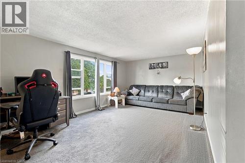 Light gray wall paint, textured ceiling, and light gray carpet - 135 Cedarhill Crescent, Kitchener, ON 