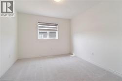 Spare room featuring light colored carpet - 