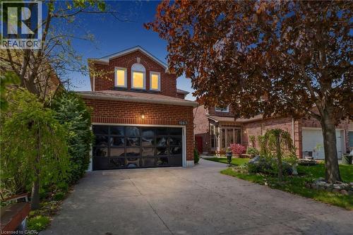 Red brick exterior featuring a single vehicle garage - 1263 Bantham Street, Mississauga, ON 
