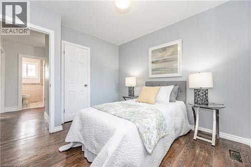 Wood-finish flooring throughout, light-toned wall paint, and white trim - 388 Appleby Line, Burlington, ON 