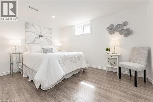 Wood-finish flooring throughout, recessed ceiling lighting, a single window, and white painted walls - 388 Appleby Line, Burlington, ON 
