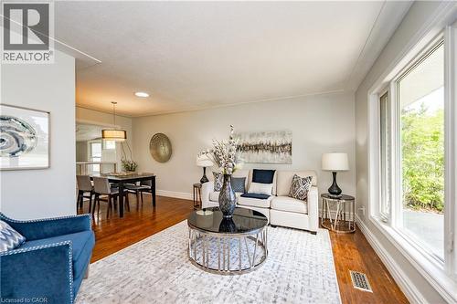 Hardwood flooring, crown molding, and large windows with white trim - 388 Appleby Line, Burlington, ON 