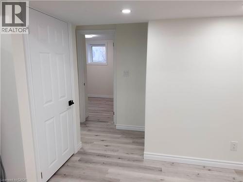Recessed lighting, light wood-finish flooring, white paneled doors, white trim, and a white window frame - 304 Westpark Crescent, Waterloo, ON 