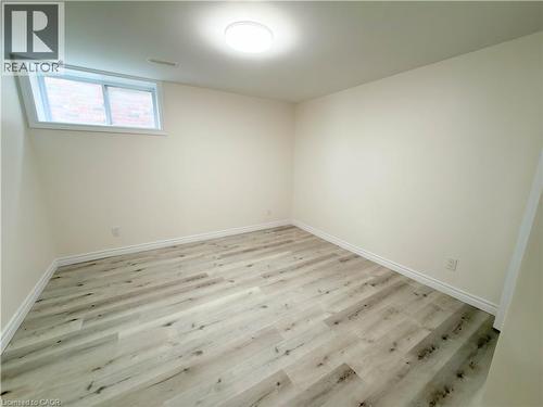 Recessed window, wood-finish flooring, flush mount lighting, and neutral wall tones - 304 Westpark Crescent, Waterloo, ON 