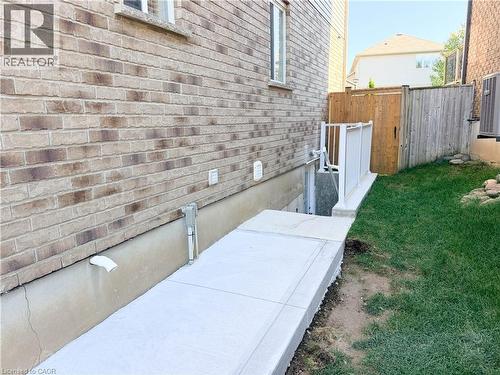 Brick exterior with a concrete walkway and a fenced yard - 304 Westpark Crescent, Waterloo, ON 