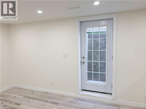 Recessed ceiling lighting, wood-finish flooring, white trim, and a white door with divided lites - 304 Westpark Crescent, Waterloo, ON 