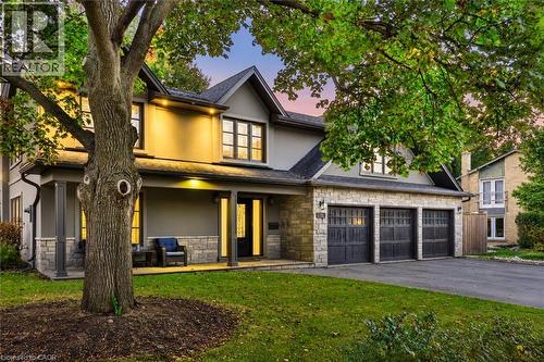 Stone and stucco exterior with a covered front porch, three-car garage, and established landscaping - 52 Joymar Drive, Mississauga, ON 