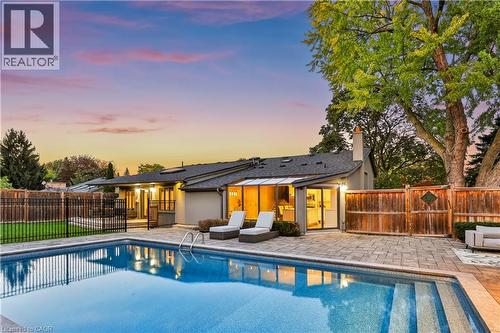 Outdoor swimming pool with integrated steps, surrounded by a paver patio - 52 Joymar Drive, Mississauga, ON 