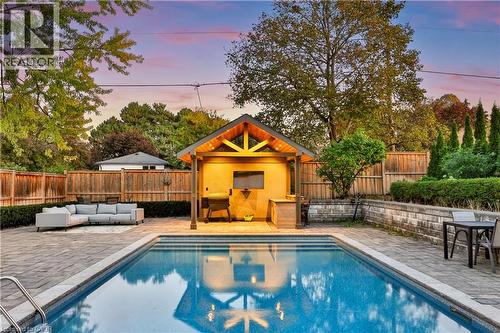 In-ground swimming pool with integrated steps, surrounded by paver patio - 52 Joymar Drive, Mississauga, ON 