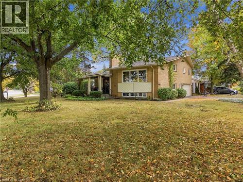 Brick exterior residence with a covered porch entry, multi-pane windows, and an attached garage - 617 Scenic Drive, Hamilton, ON 